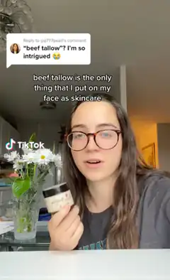 Girl holding beef tallow jar with comment overlay