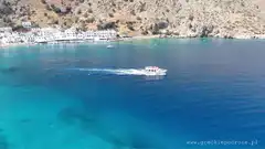 Boat cruising in turquoise bay