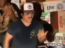 Man in trucker hat dancing