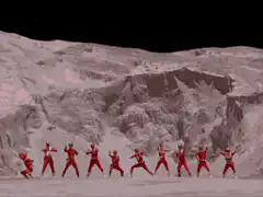 Red Rangers pose in front of explosion