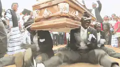 pallbearers dancing with coffin