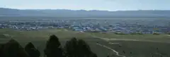 Aerial view of a vast wetland with distant mountains