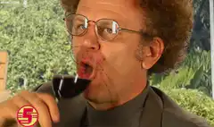 Man spilling red wine on himself