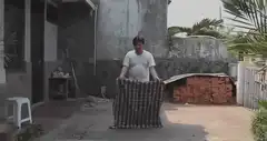 Man disappears behind a curtain