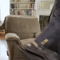 man falls into armchair exhausted