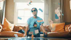 Man in sunglasses surrounded by falling money