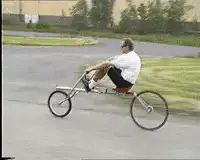 man riding a long recumbent bike