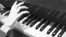 Hand playing Steinway piano keys