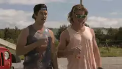 Two men talking outside with drinks