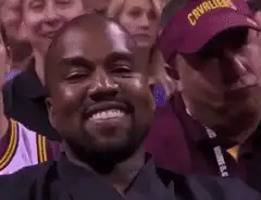 Kanye West smiling then turning serious
