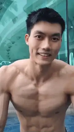 Shirtless man smiling in pool