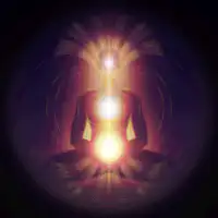 meditating figure with glowing chakras