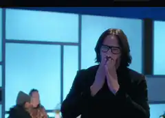 Keanu Reeves hands to mouth then claps