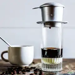 Vietnamese coffee drips into glass