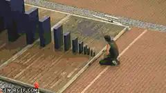 Giant dominoes falling on a track