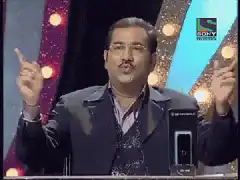 Man gesturing with hands on stage