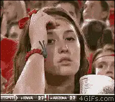 Woman at basketball game smiles