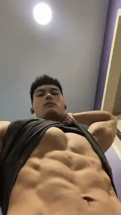 Man lifting shirt to show abs