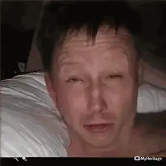 Man lying in bed with tired face