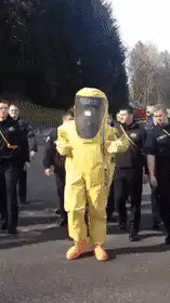 Person in yellow hazmat suit dancing