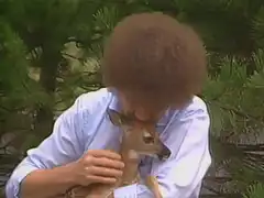 Bob Ross holding a baby deer