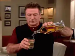 Alec Baldwin pouring a drink