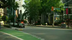 Car driving through city street with fire trail
