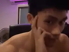 shirtless man touching face