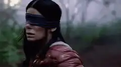 Blindfolded woman in forest