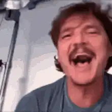 Pedro Pascal laughing and waving