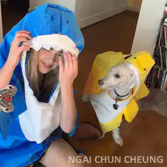 Girl and dog in shark costumes with flying butterfly