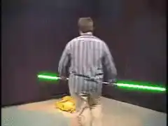 Man with lightsabers burns a yellow cloth