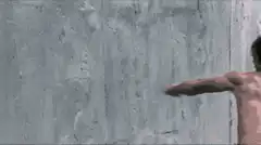 Man punches through concrete wall