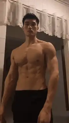 Shirtless man flexing muscles