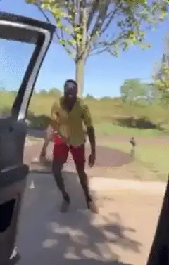 Man dancing outside car door