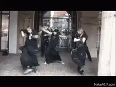 Goth band dancing in a courtyard
