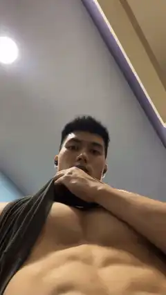 shirtless man pulling shirt