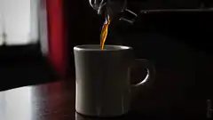 Pouring coffee into a white mug