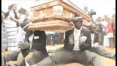 pallbearers dancing with coffin