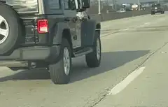 Jeep driving on highway