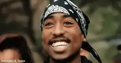 2Pac smiling and pointing