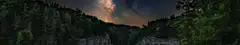 Milky Way over forested cliffs
