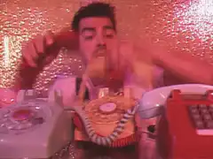 Joe Jonas surrounded by phones