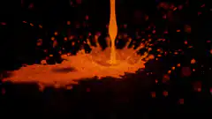Orange liquid splash slow motion