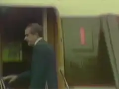 Richard Nixon waving from airplane