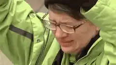 Person in green jacket screaming