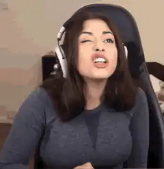 Woman winking and singing with headphones