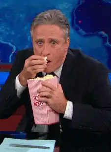 Jon Stewart eating popcorn