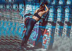 woman stretching against graffiti wall