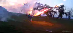 Man firing rocket launchers in a field